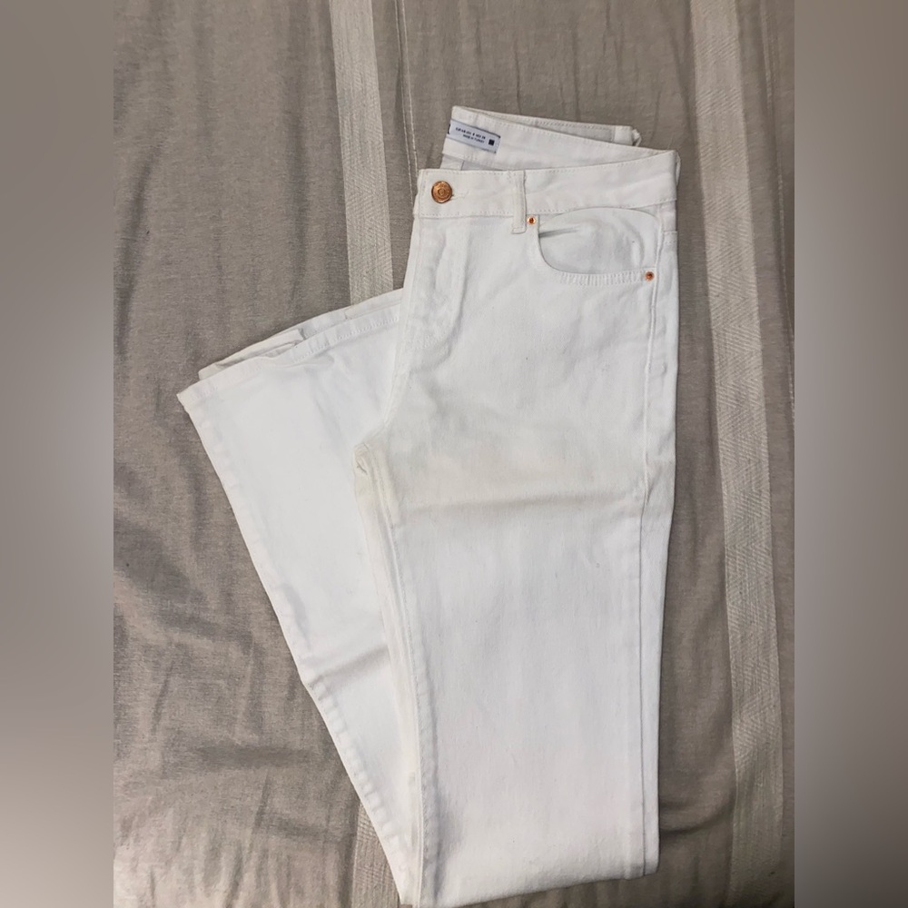 White flared Zara jeans with rose gold detailing